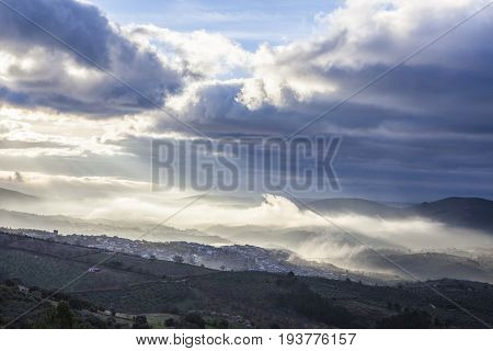 Stunning overview of Guadalupe village during a foggy sunrise Caceres Spain