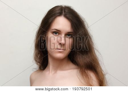 Portrait nude young brunette woman with long hair