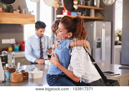 Mother Saying Goodbye To Son As She Leaves For Work