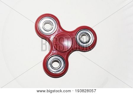 An isolated fidget spinner on an angle laying on a white background.