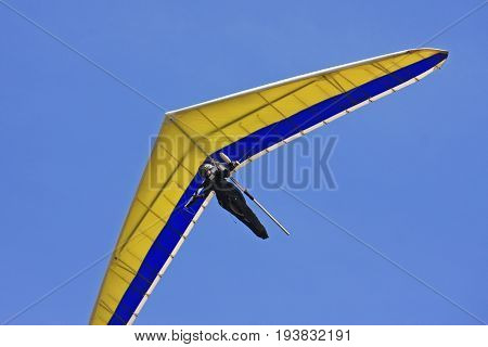 Hang glider flying his wing in a blue sky