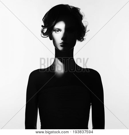 Black and white art fashion surrealistic portrait of beautiful woman with a beam of light on her face