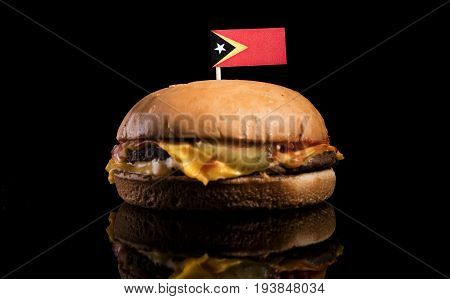 East Timorese Flag On Top Of Hamburger Isolated On Black Background
