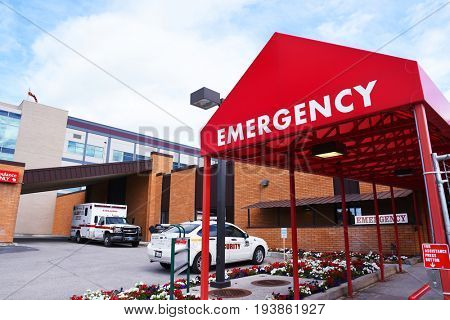 KALISPELL, MONTANA, USA - June 19, 2017: Emergency room entrance at Kalispell Regional Medical Center with an ambulance and security car in the background