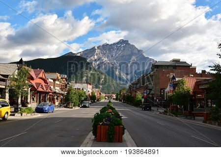 Banff Alberta Canada,July 6th 2014.Main street Banff Alberta with hotels and shops and beautiful Mount Norquay in the background .Come to Banff and create memories.