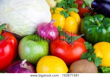 Close-up of fruits and vegetables. Cabbage tomato apple pepper herbs onions kiwi lemon