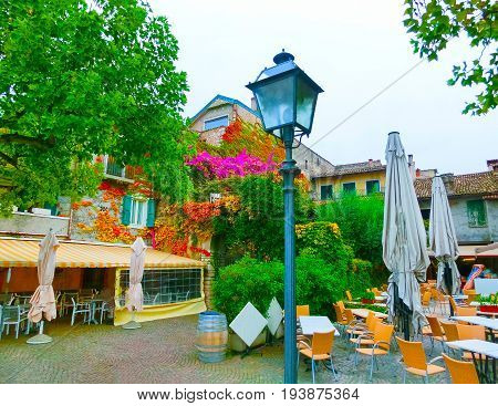 The fasade with flowers at old town at Torri del Benaco at Garda Lake in Italy