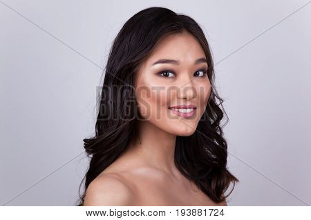 Portrait of a beautiful asian woman with naked shoulders.