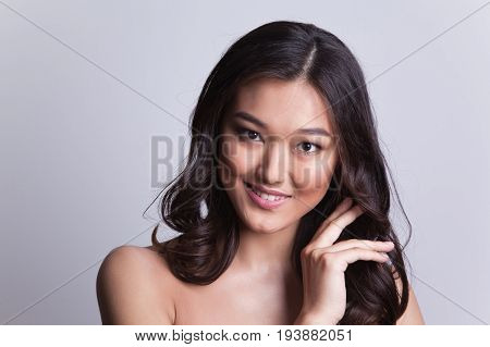 Portrait of a beautiful asian woman with naked shoulders.