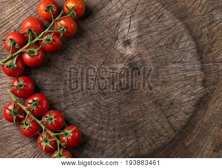 Top view of a Ripe tasty red tomatoes. Village market organic tomatoes on wooden board with copy space. View from above of Fresh tomato. Qualitative background from tomatoes. Detox contept
