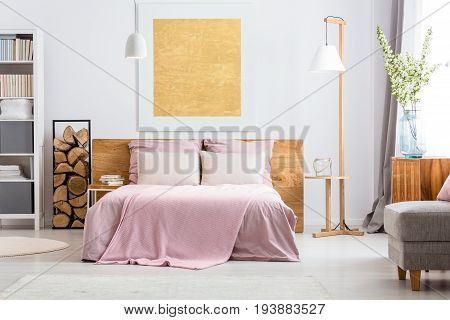 Natural decor of cozy white and pink bedroom with wooden additions