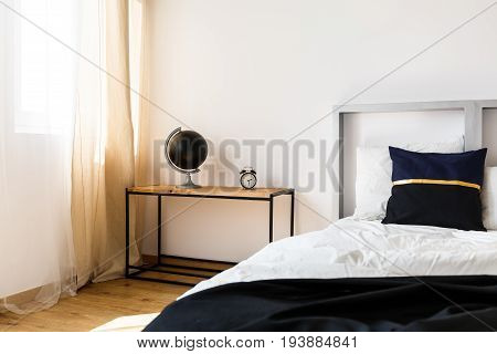 Modern design of grey headboard of cozy bed in white bedroom