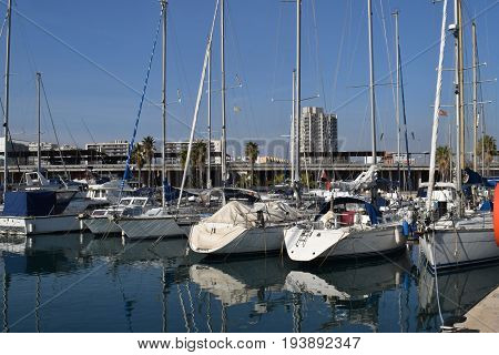 Ships sailboats yachts tied in the port