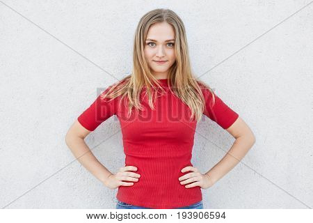 Youth And Beauty Concept. Pretty Young Woman With Straight Light Hair Looking Confidently With Her B