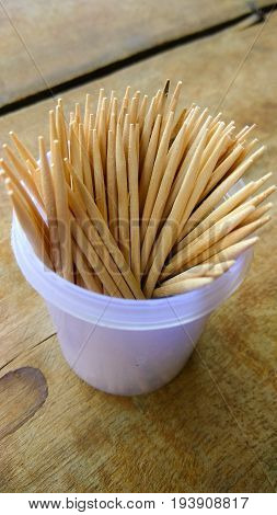 abstract wooden tooth picks on wood background