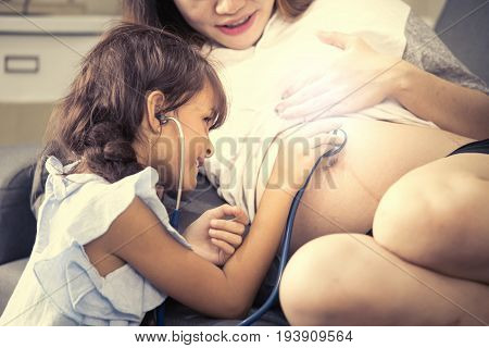 Little Cute Girl Using Stethoscope Check Stomach Her Mother Vintage Tone.