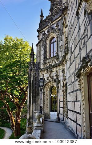 SINTRA, PORTUGAL - JUNE 10 2017: Palace Quinta da Regaleira Sintra Portugal. Palace with symbols related to alchemy Masonry the Knights Templar and the Rosicrucians shown at sunset. Masterpiece of Neo-Manueline architecture style
