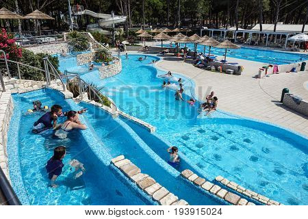 Torvaianica, Italy - July 2017: People having fun in the swimming pool in water park at Zoomarine acqua park .