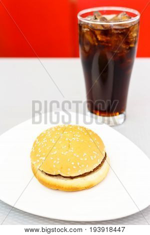 Hamberger on whtie plate and ice cola - color filter processing.