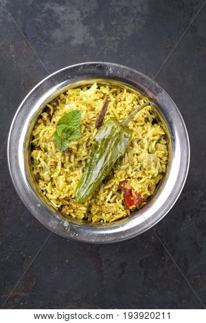 Indian Vegetable Biryani with Sweet Pepers as close-up in a Korai