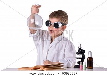 Scientist boy in black glasses glad and holds empty flask in his hand