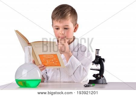 Science boy reads book at chemistry lab at the desk white background