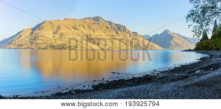 Panoramic serenity of beautiful Lake Wakatipu in the morning in Autumn Queenstown South Island of New Zealand