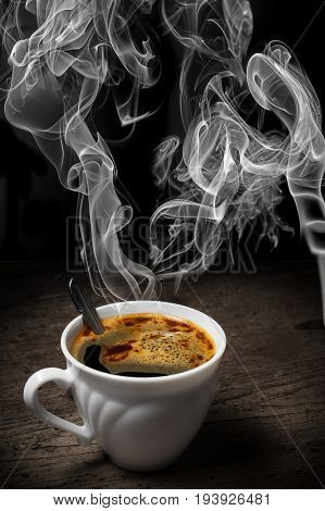 a cup of coffee on an old wooden table - vintade style