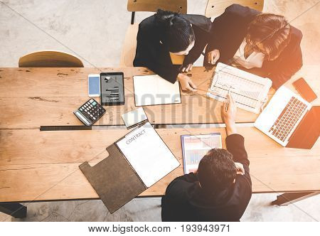 Top view business partners discussing contract and graph of financial report. Business Concept