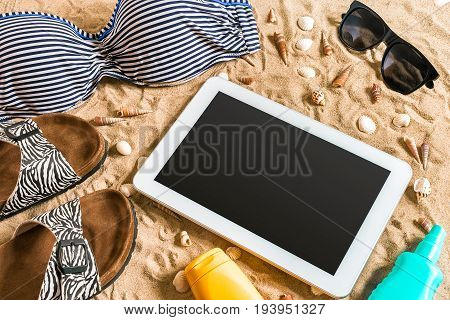 Summer bikini and accessories stylish beach set, Beach bikini summer outfit and sea sand as background, Top View, Concept. Copy space. Still life mockup flat lay