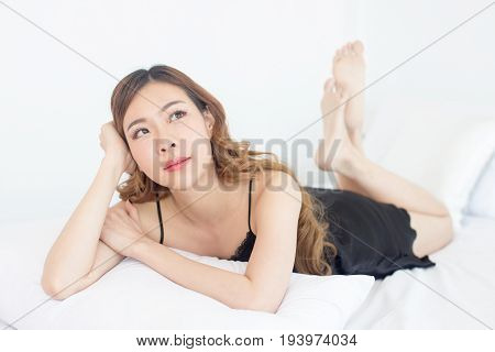 Beautiful young asian woman posing on the bed korean woman sexy concept 20s year old.
