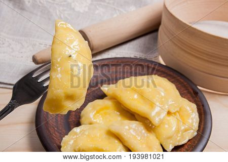 Close Up View Of Boiled Varenyky Or Dumpling With Cottage Cheese Or Curd On Metal Fork. Fresh Boiled