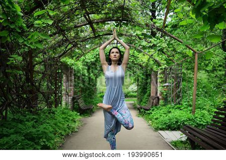 Portrait of woman doing youga in park. Shallow depth of field
