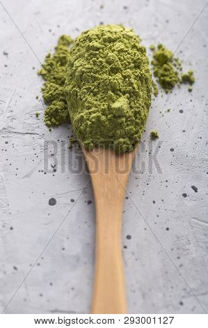 Green Tea Matcha In A Spoon On Concrete Surface. Close Up Shot