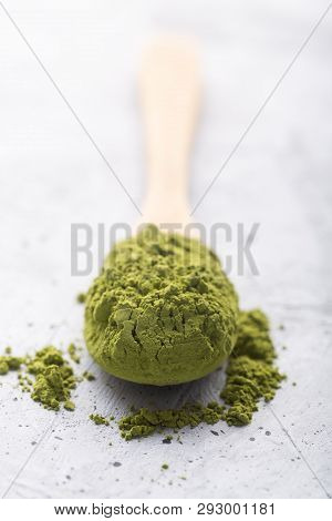 Green Tea Matcha In A Spoon On Concrete Surface. Close Up Shot