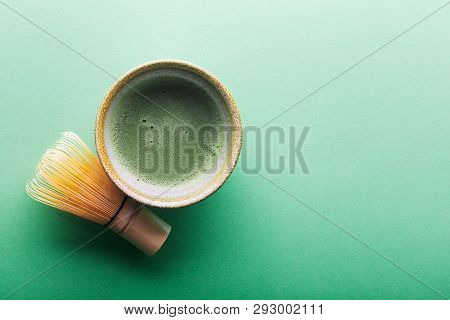 Top View Of Tea Matcha In A Bowl And Chasen On Greeen Surface