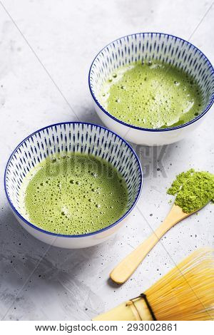 Green Tea Matcha In A Bowls And Chasen On Concrete Surface