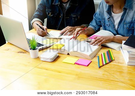 Woman And Man Work On The Table With Notebook Laptop Paper Work  And Color Pen, In Concept Of Educat