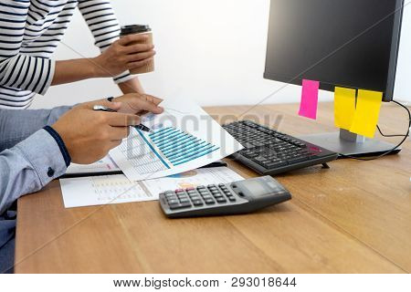 businessman and business woman work with friend on the table with computer laptop calulator ,working