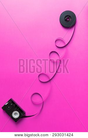 Retro Film For Old Video Camera With Video Cassetta On Al Pink Paper Backgound, Abstract Creative Co