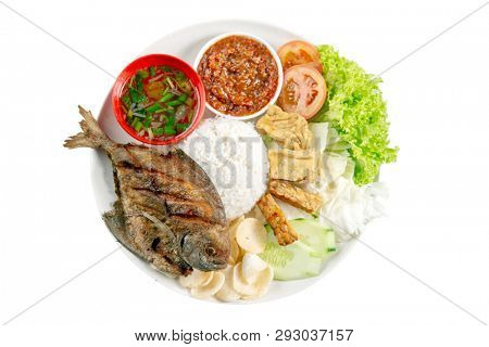 Fried pomfret fish and rice, popular traditional Malay or Indonesian local food. Isolated on white background. Flat lay top down overhead view.