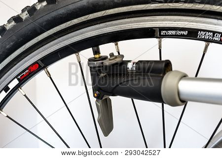Bonn, Germany - March 29, 2019. Pumping The Bicycle Wheel Using A Hand Pump With Air Pressure Indica