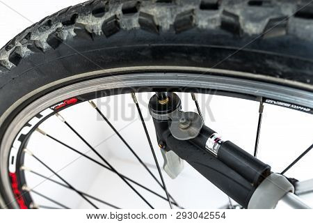 Bonn, Germany - March 29, 2019. Pumping The Bicycle Wheel Using A Hand Pump With Air Pressure Indica