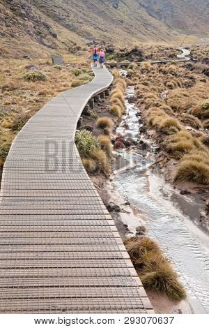 Wooden boardwalk at Tongariro Alpine Crossing tramping track, one of the most popular day hikes in New Zealand. Track crossing the Tongariro National Park, the oldest national park