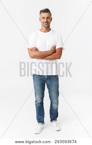 Full length image of handsome man 30s wearing casual t-shirt and jeans smiling on camera isolated over white background