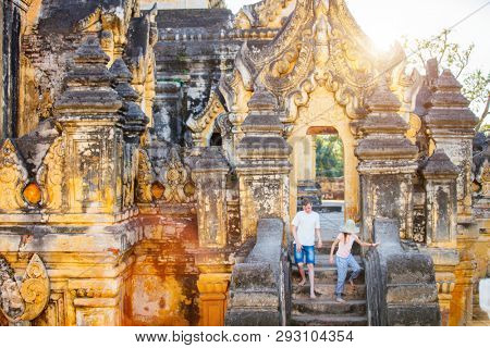 Kids brother and sister visiting ancient Maha Aung Mye Bonzan Monastery one of the most beautiful landmarks of Royal City of Inwa in Myanmar
