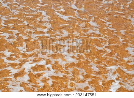 Ocean Wave Water And Foam On A Yellow Sand Of Tropical Beach.abstract Background.natural Texture.