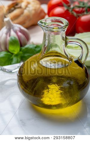 Virgin Natural Olive Oil Is Glass Bottle, Served With Traditional Mediterranean Food