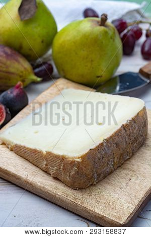 Piece Of French Cheese Tomme De Brebis Made From Sheep Milk Served As Dessert With Fresh Figs And Pe
