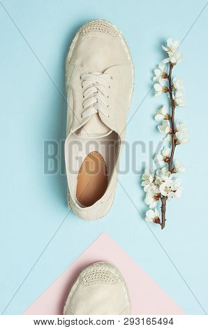Beige Fashionable Women's Espadrilles With Spring Flowering Branch On Color Pastel Blue Pink Backgro